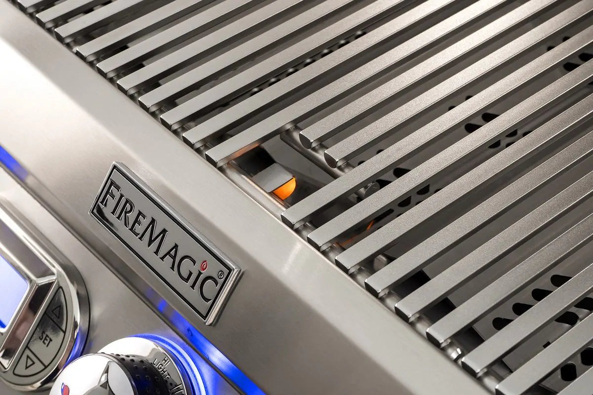 Fire Magic grill side control panel with FireMagic badge and blue burner light