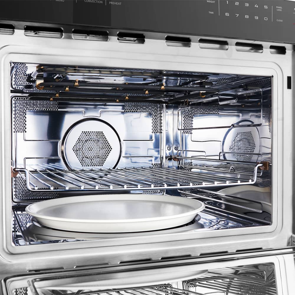 Stainless steel dishwasher interior with bottom rack and spray arms