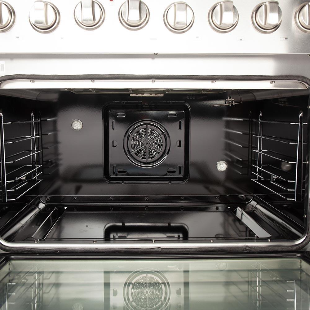 Dual fuel range oven cavity with rear convection fan and wire racks