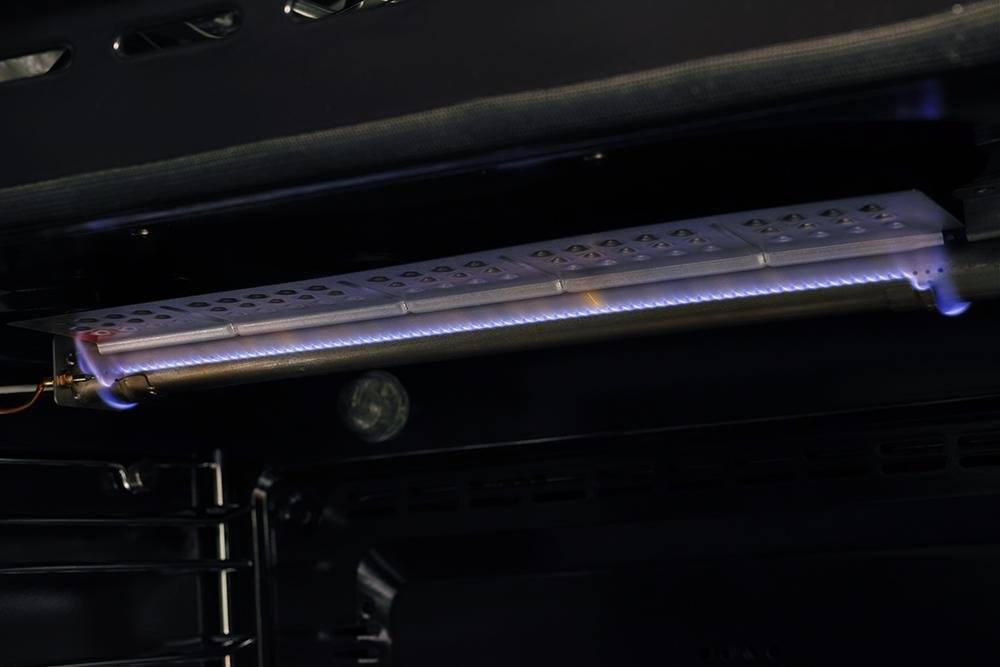 Gas range broiler burner with blue glow under oven cavity