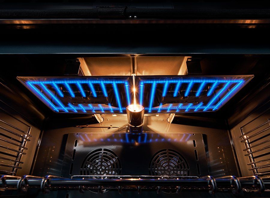 Gas oven interior with blue flame glow and heating elements above