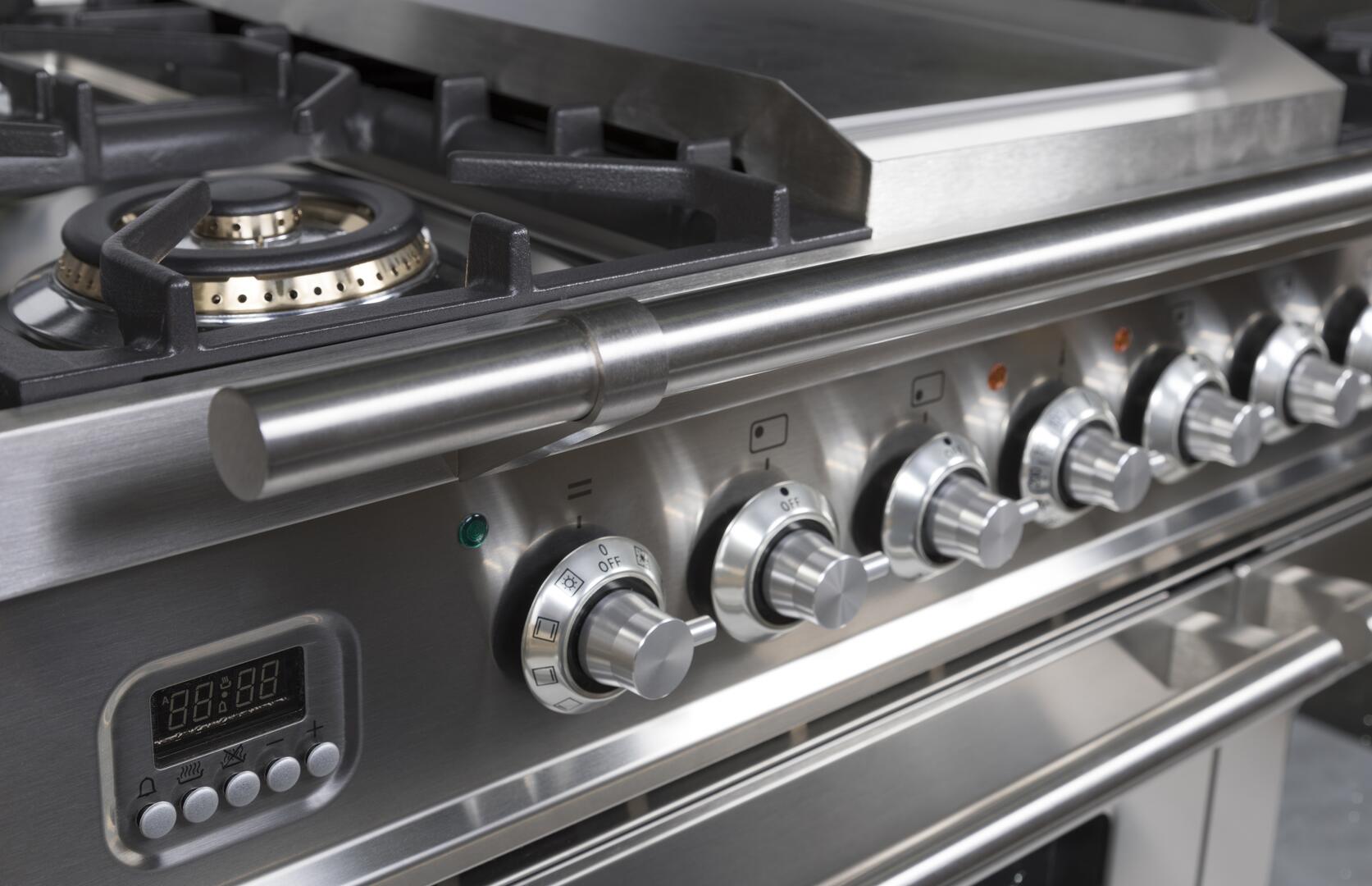 Stainless dual-fuel range control panel with knobs and digital display