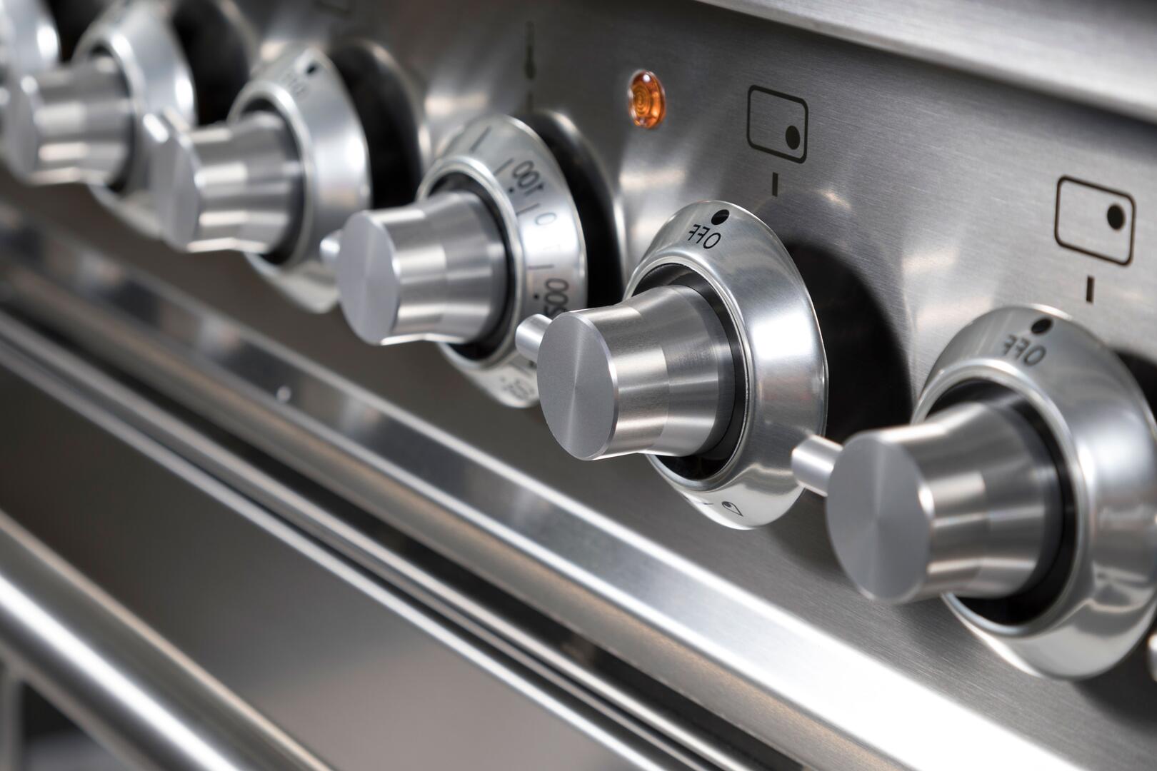 Stainless steel dual-fuel range burner control knobs and front panel