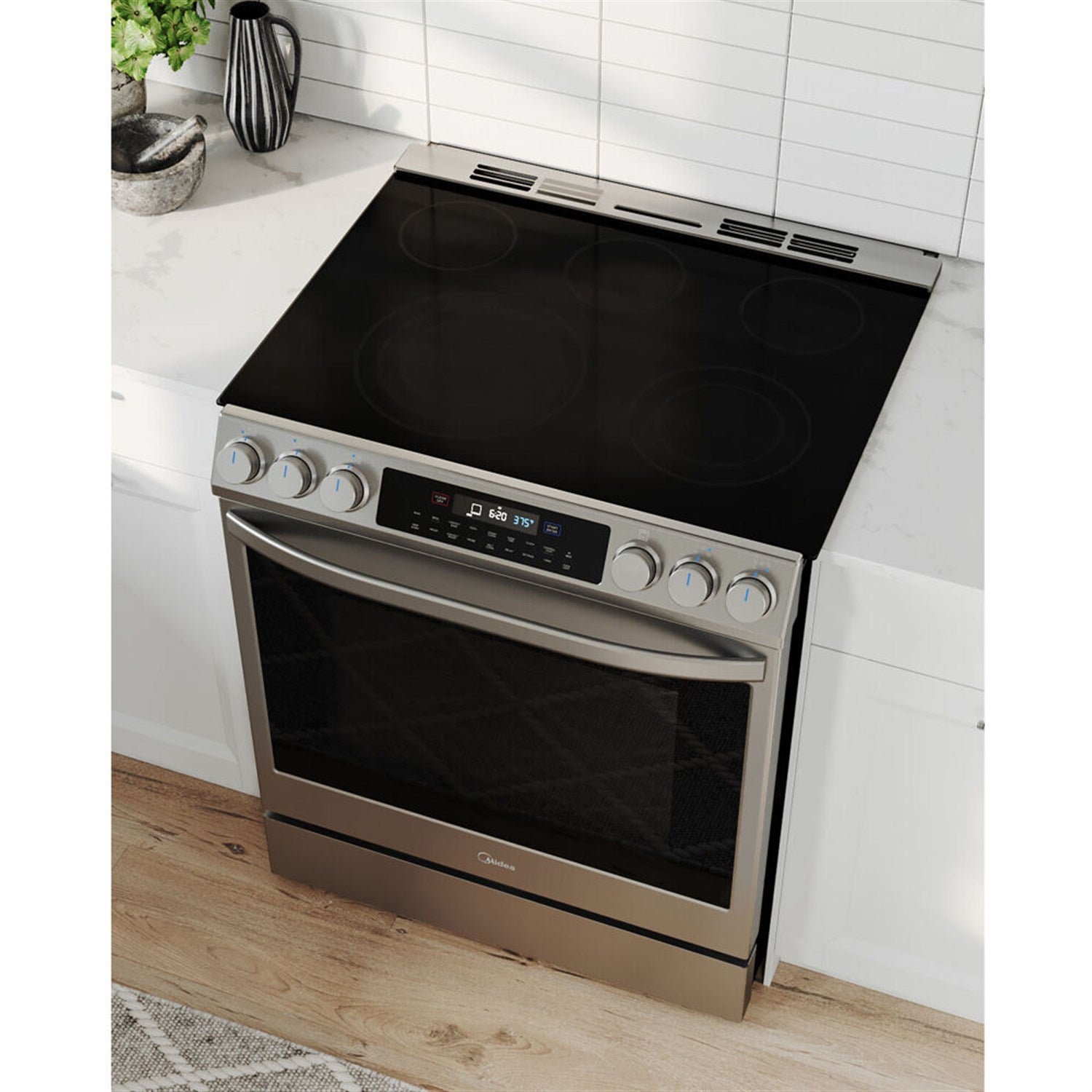 Stainless steel electric range with black glass cooktop and closed oven door