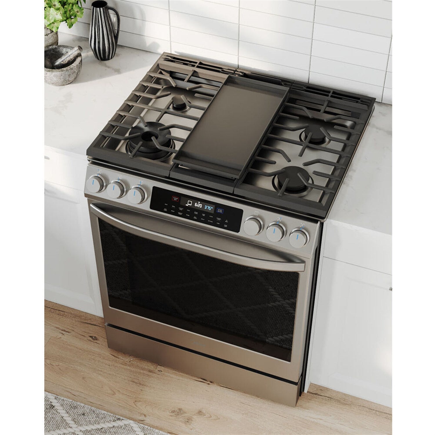 Stainless steel slide-in gas range with five burners and closed oven door