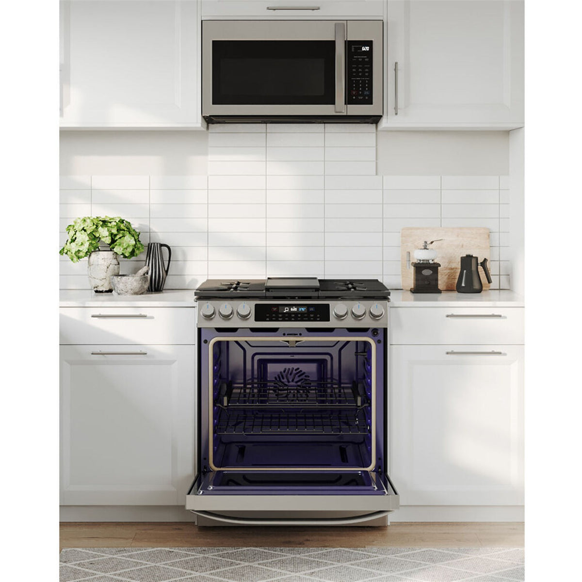 Stainless steel slide-in gas range with open oven door showing dark interior racks
