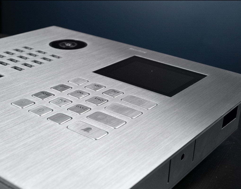 Close-up of stainless steel DoorBird keypad and display area with camera at top