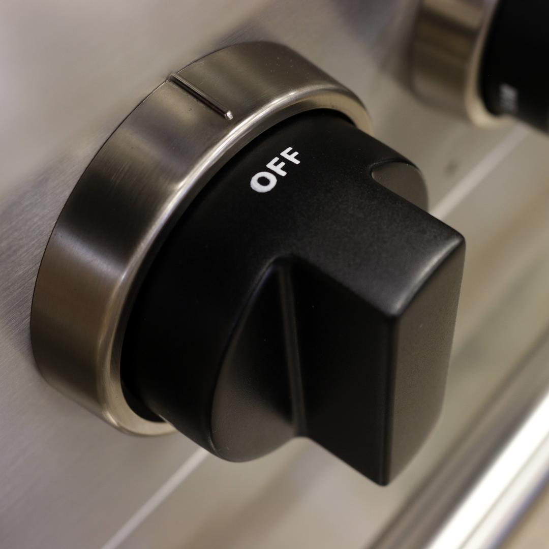 Stainless steel range control knob with OFF indicator on a black dial face