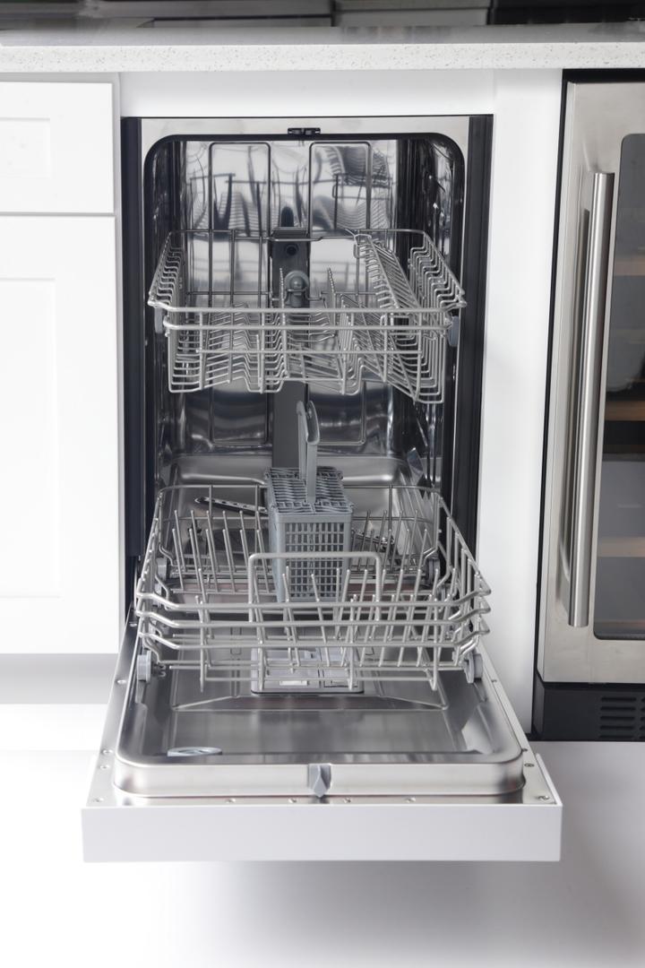 Dishwasher interior with metal racks and spray arms
