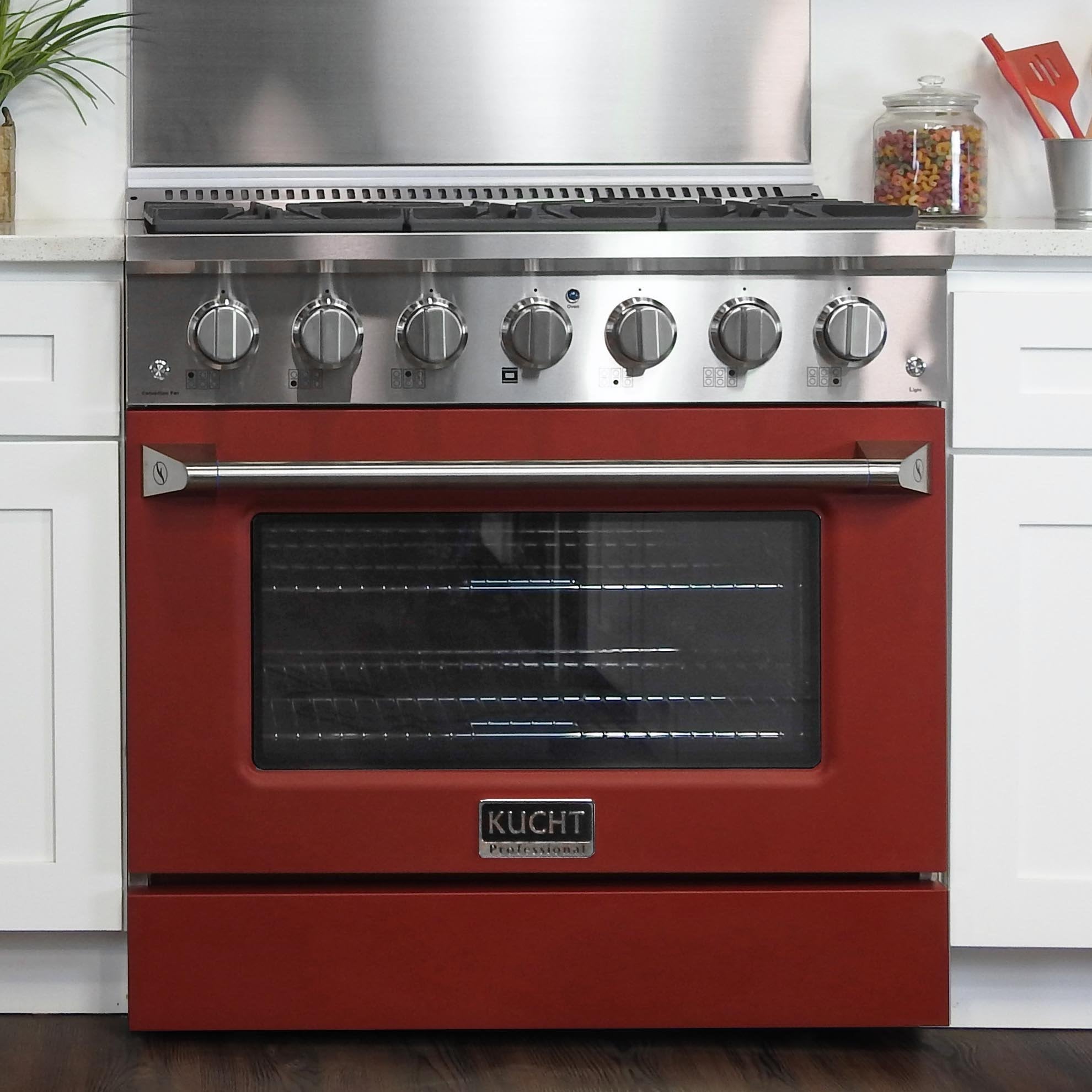 Red and stainless gas range with six burner knobs and oven door window
