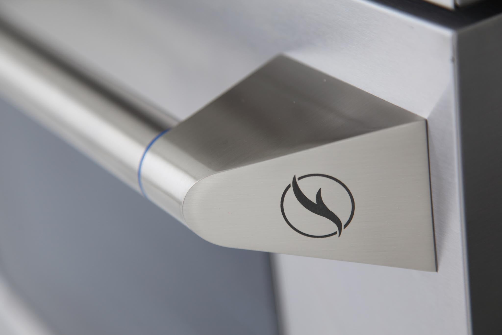 Stainless steel oven door handle with flame icon, close-up