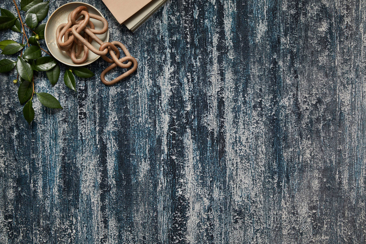 Hand-tufted area rug in blue and gray with distressed abstract stripes