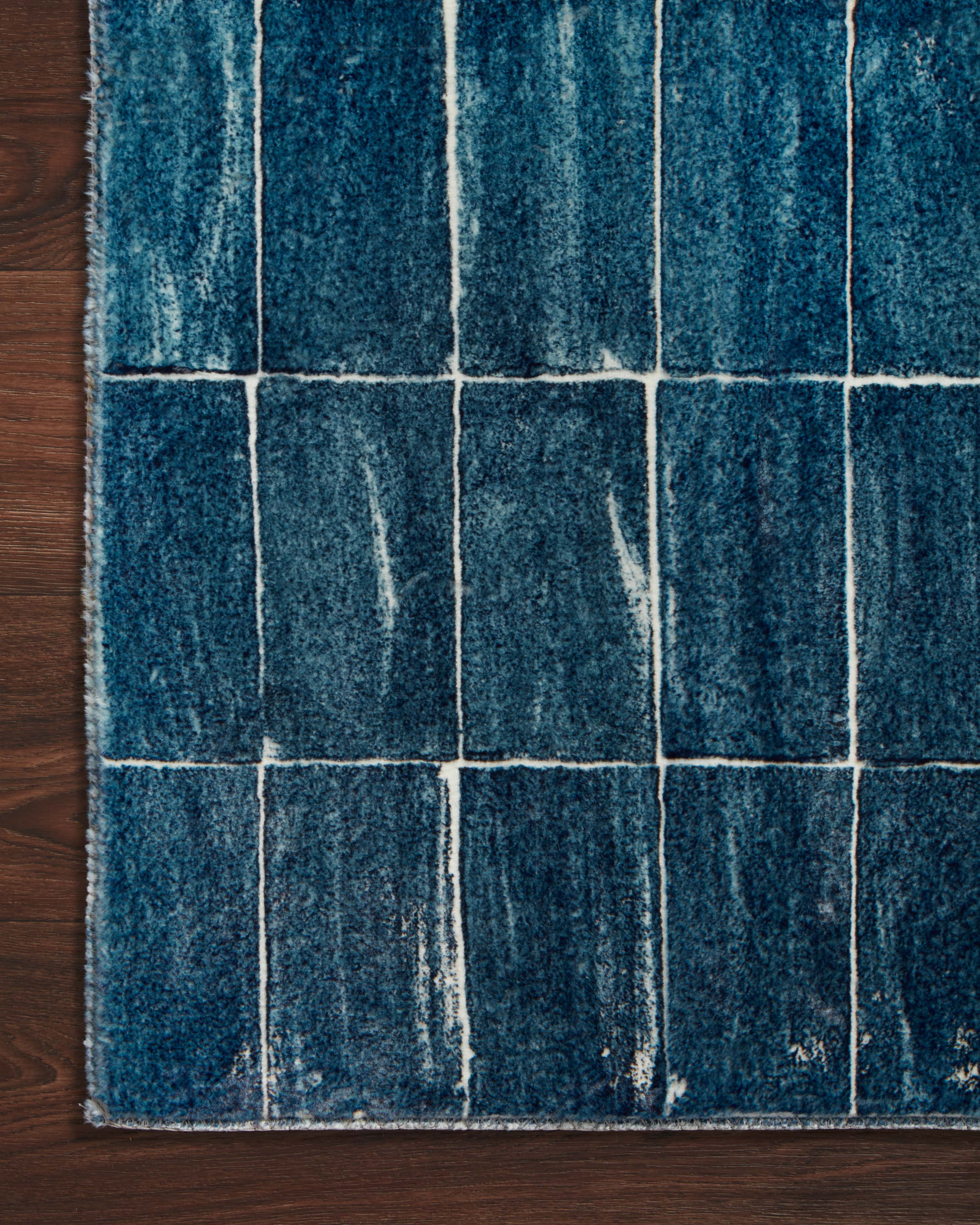 Denim and ivory tiled rug pattern, close view on hardwood floor