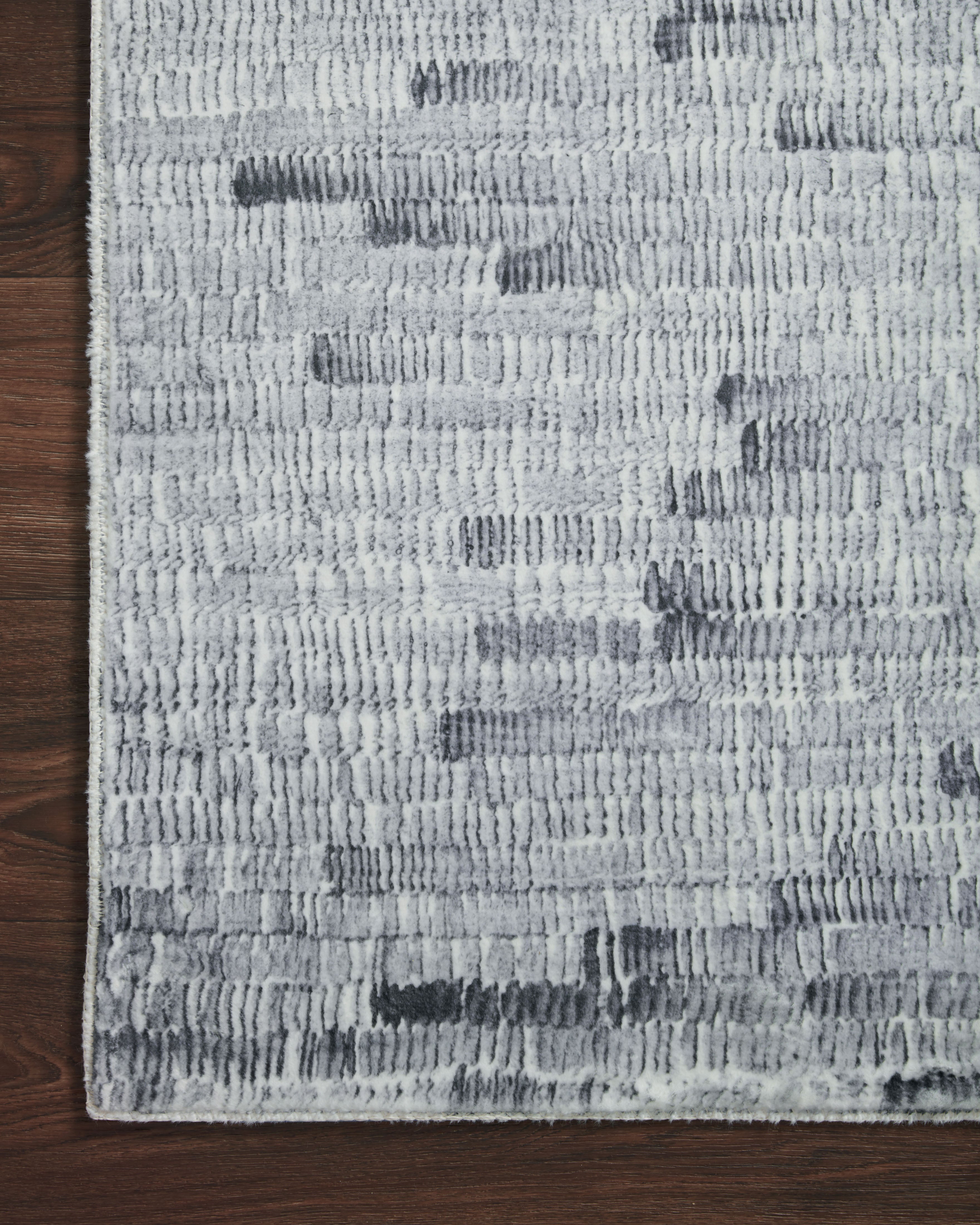 Silver and white pile rug with distressed blocks and ribbed weave texture