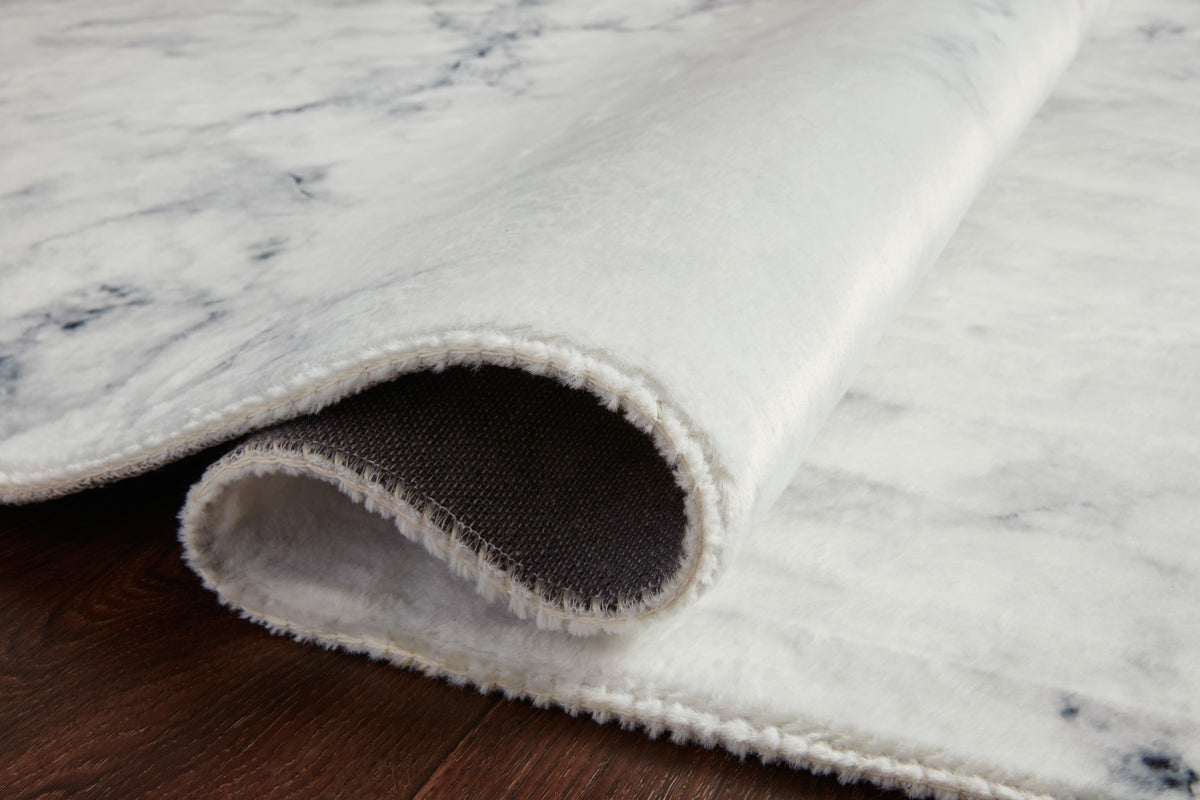 Ivory and smoke hand-tufted rug rolled edge showing short pile