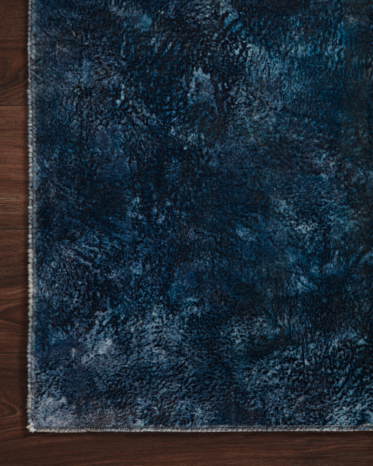 Contemporary power-loomed rug with textured abstract pattern in deep blue tones