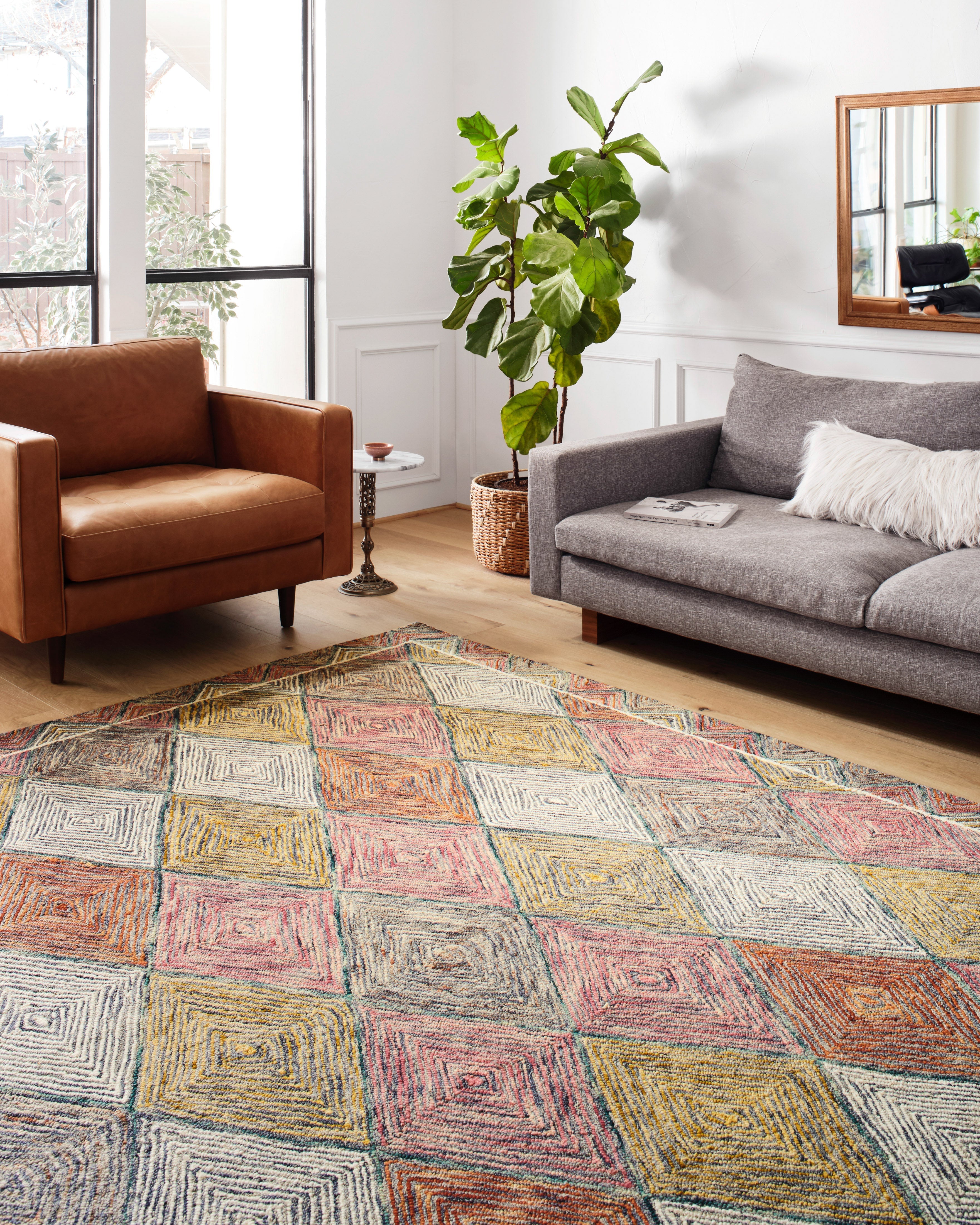 Multicolor hooked rug with diamond grid pattern in coral, blue, yellow, and gray