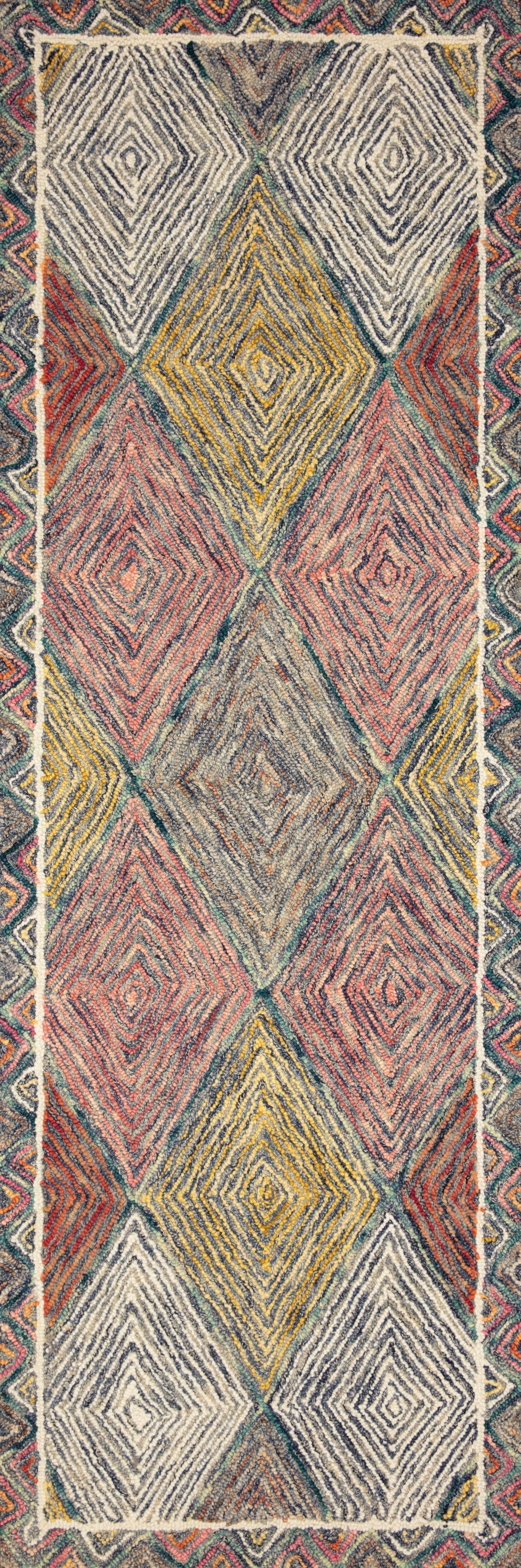 Multicolor hooked rug with tall geometric chevron and diamond pattern, turquoise and coral