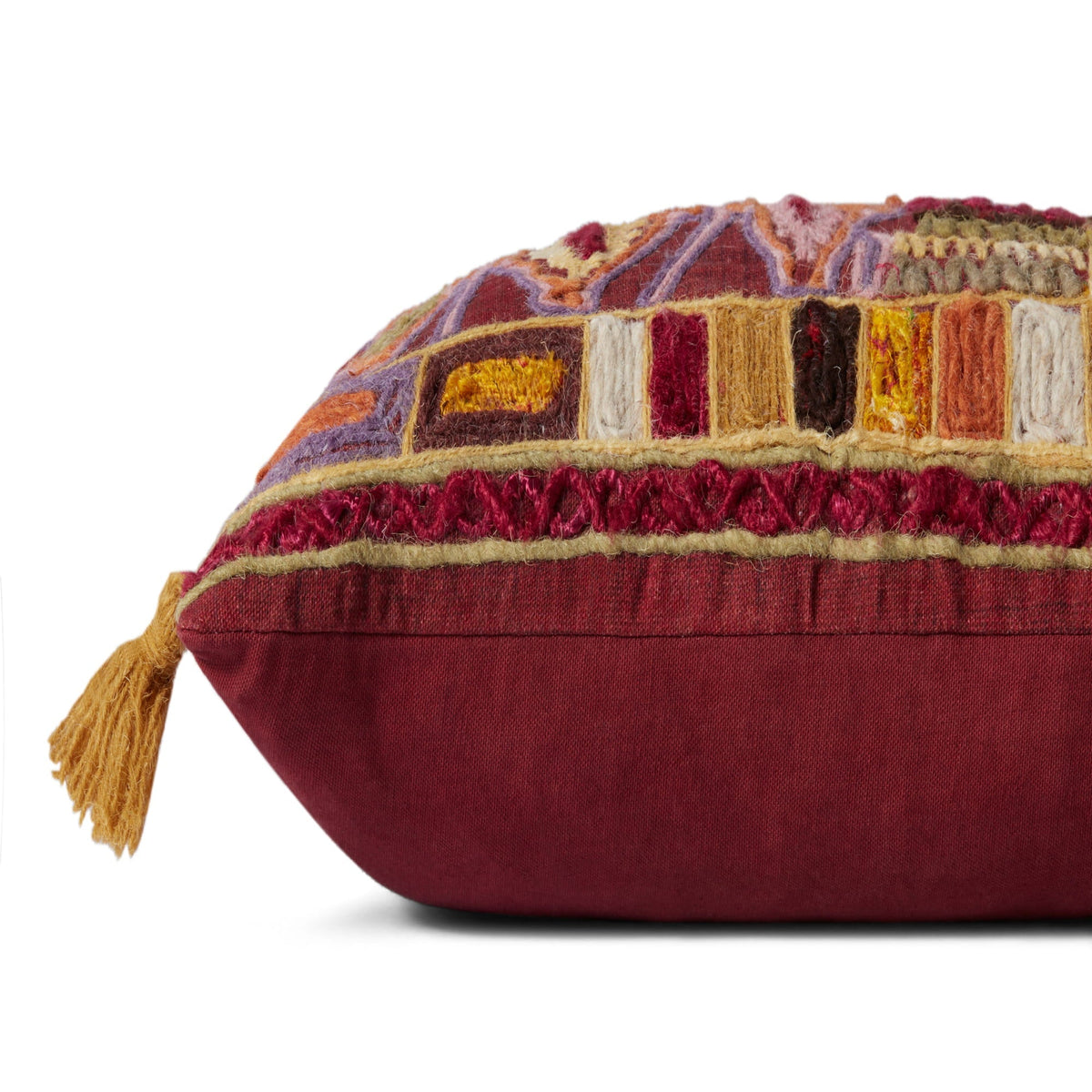 Burgundy accent pillow with multicolor embroidered bands and tassel corners
