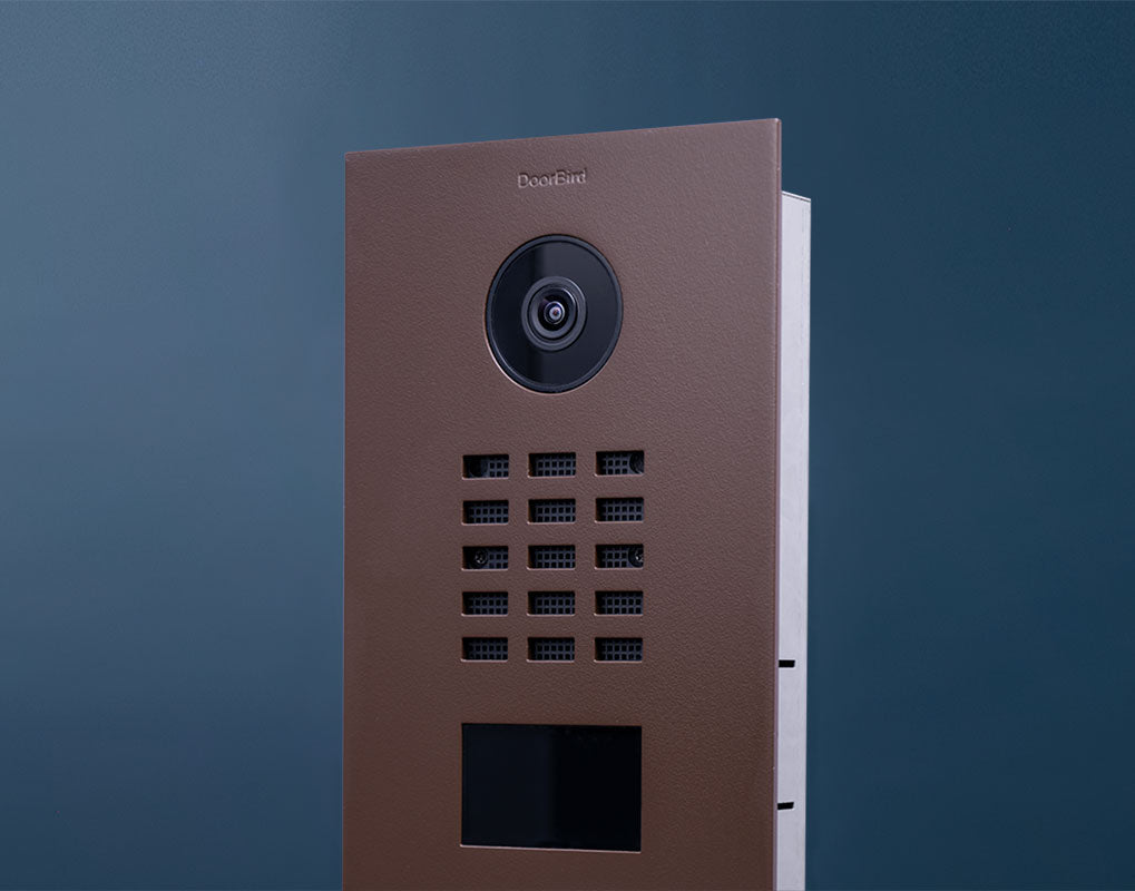 DoorBird IP video door station in nut brown, camera lens and keypad detail