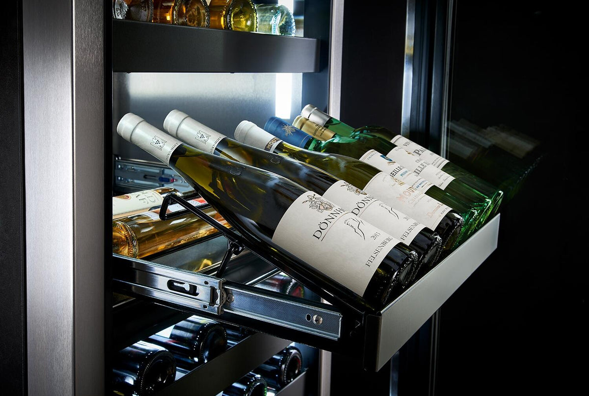 Wine cooler interior with wire racks holding upright bottles in a dual-zone layout