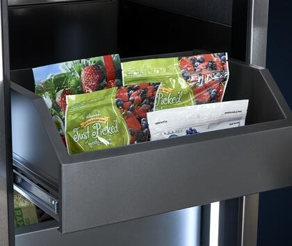 Upright built-in freezer door open with storage bin holding packaged food items