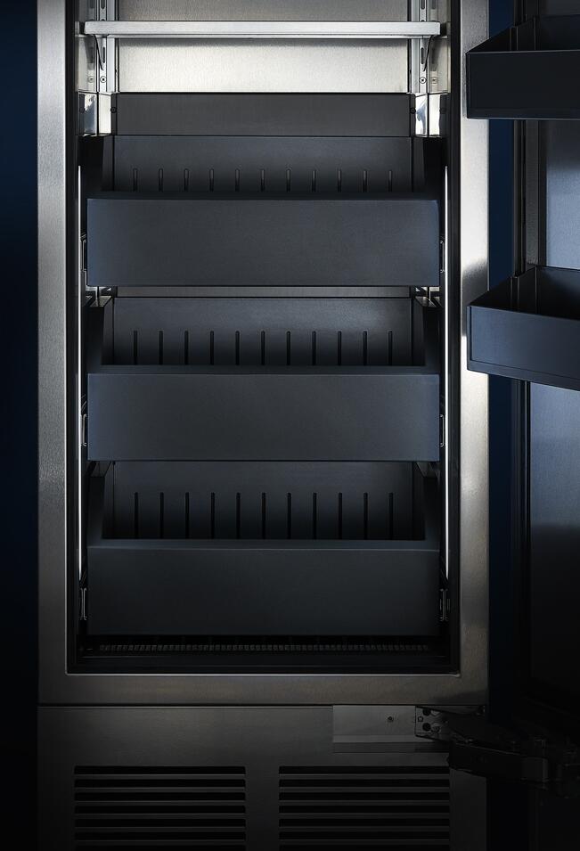 Built-in upright freezer interior with multiple shelves and door racks, open