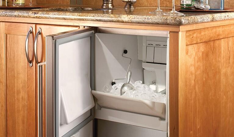 Stainless built-in ice maker with open door and ice bin