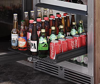 Built-in beverage center with glass door open, bottles and cans on interior shelves