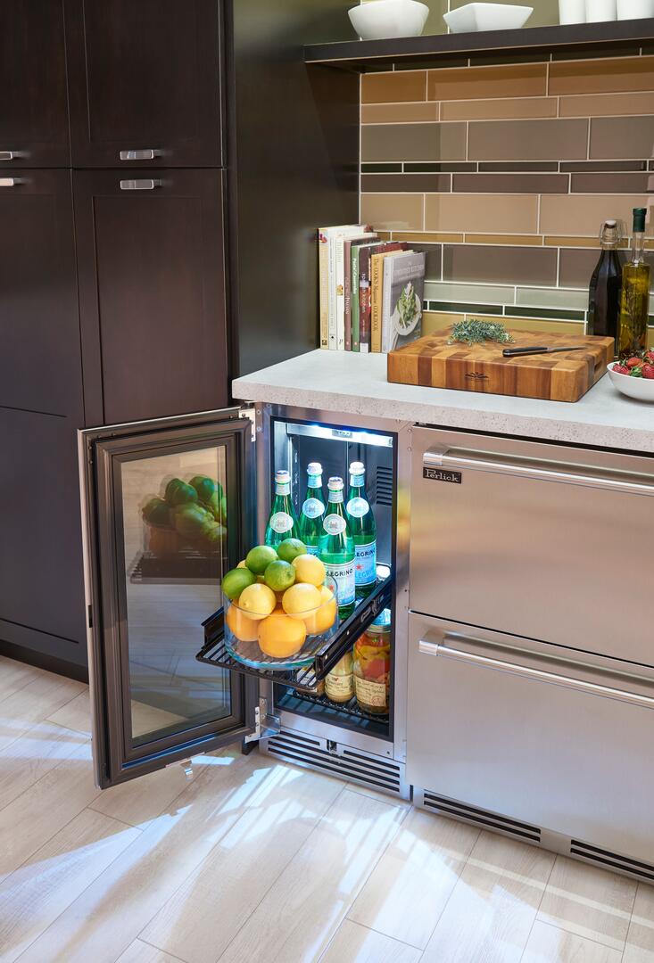 Perlick compact built-in refrigerator with open glass door, stainless frame
