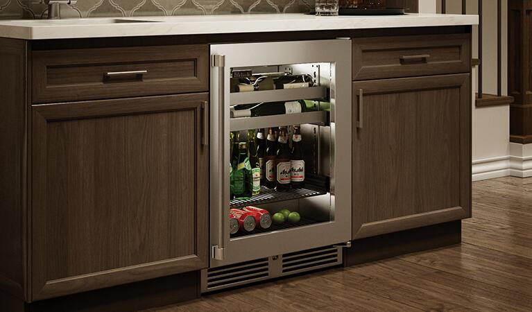 Under-counter beverage center with glass door and bottle storage in kitchen cabinetry