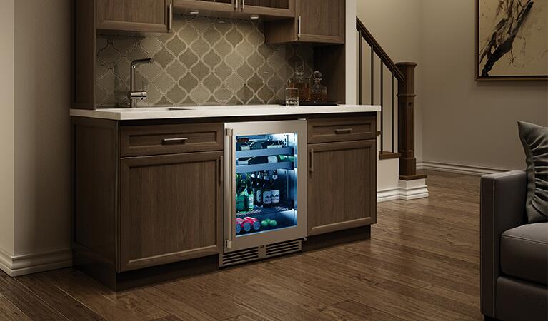 Built-in beverage cooler with glass door installed in kitchen cabinet