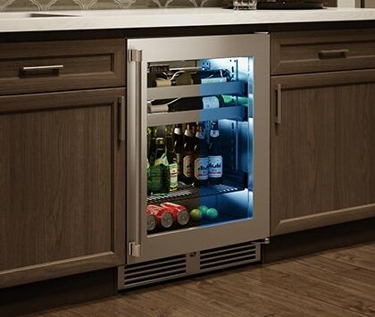Built-in beverage center cooler with open stainless door and glass front, shelving inside