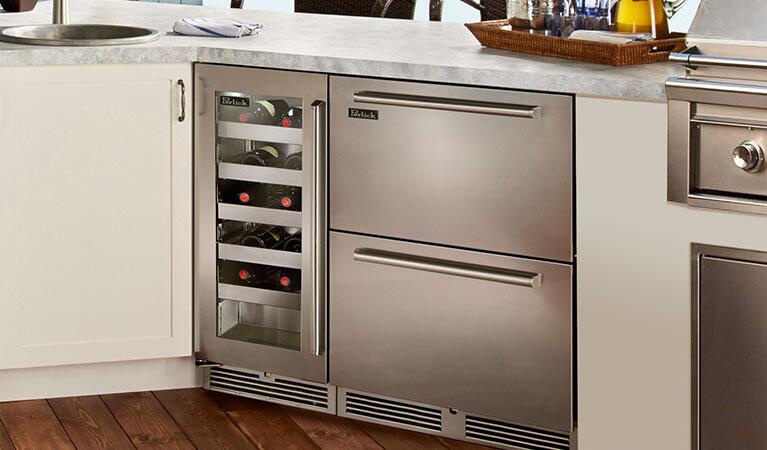 Stainless steel built-in freezer drawer open with interior shelves