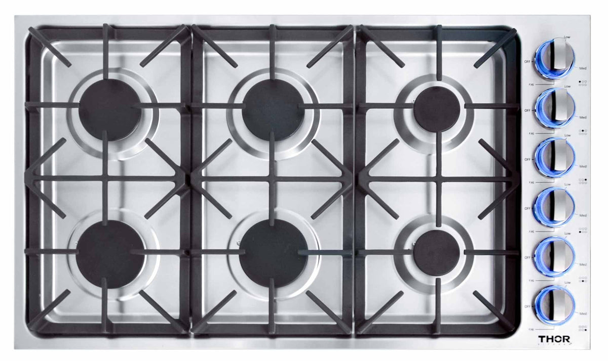 Stainless gas cooktop with six black grates and six burner knobs