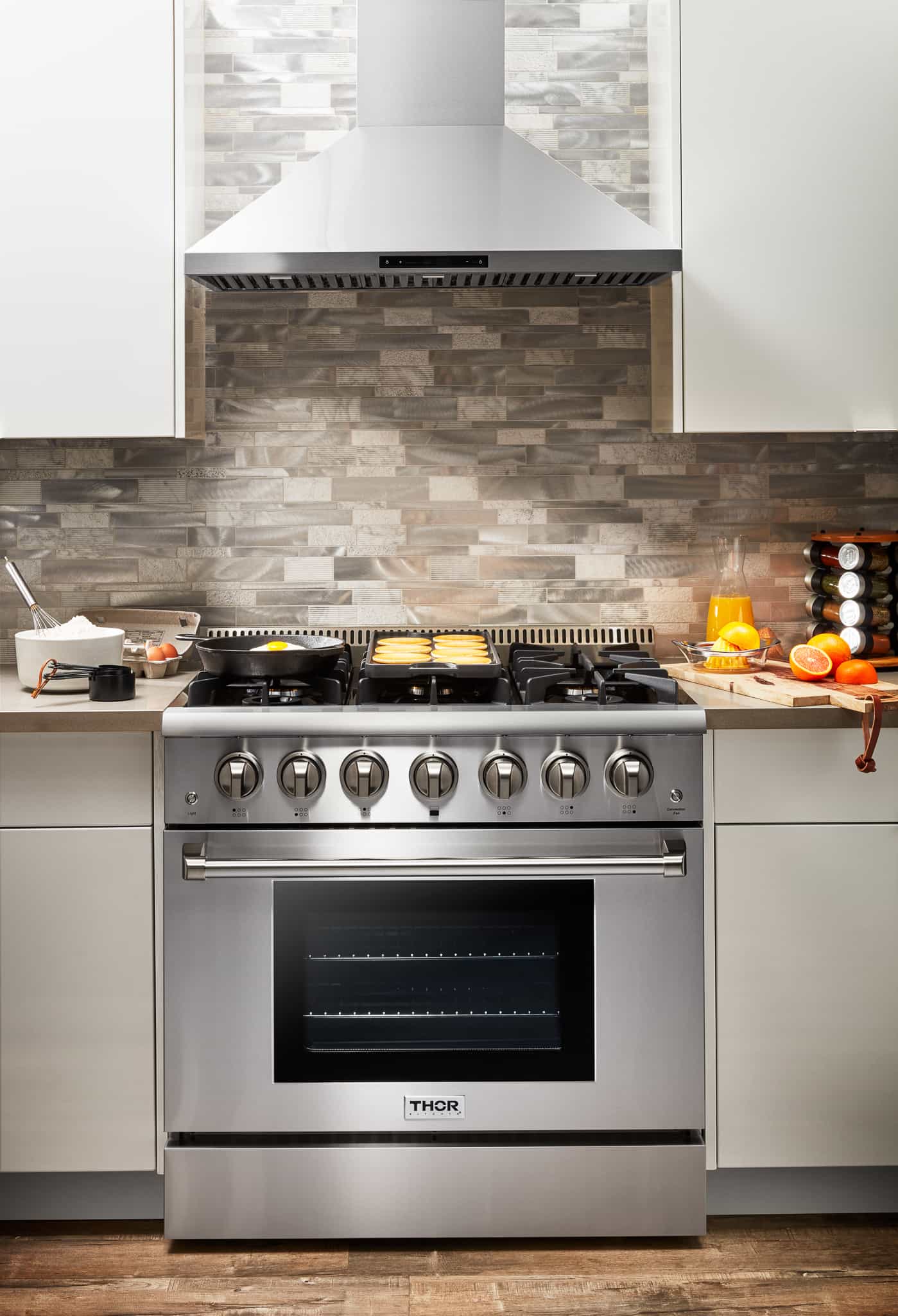 Stainless steel dual fuel range with dark oven window and burner grates