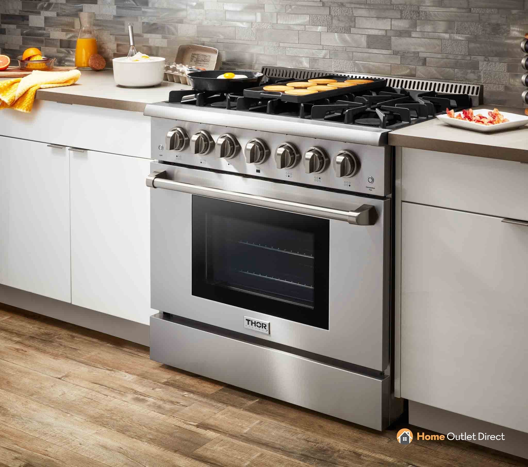 Stainless steel gas range with cooktop burners and oven with dark glass window
