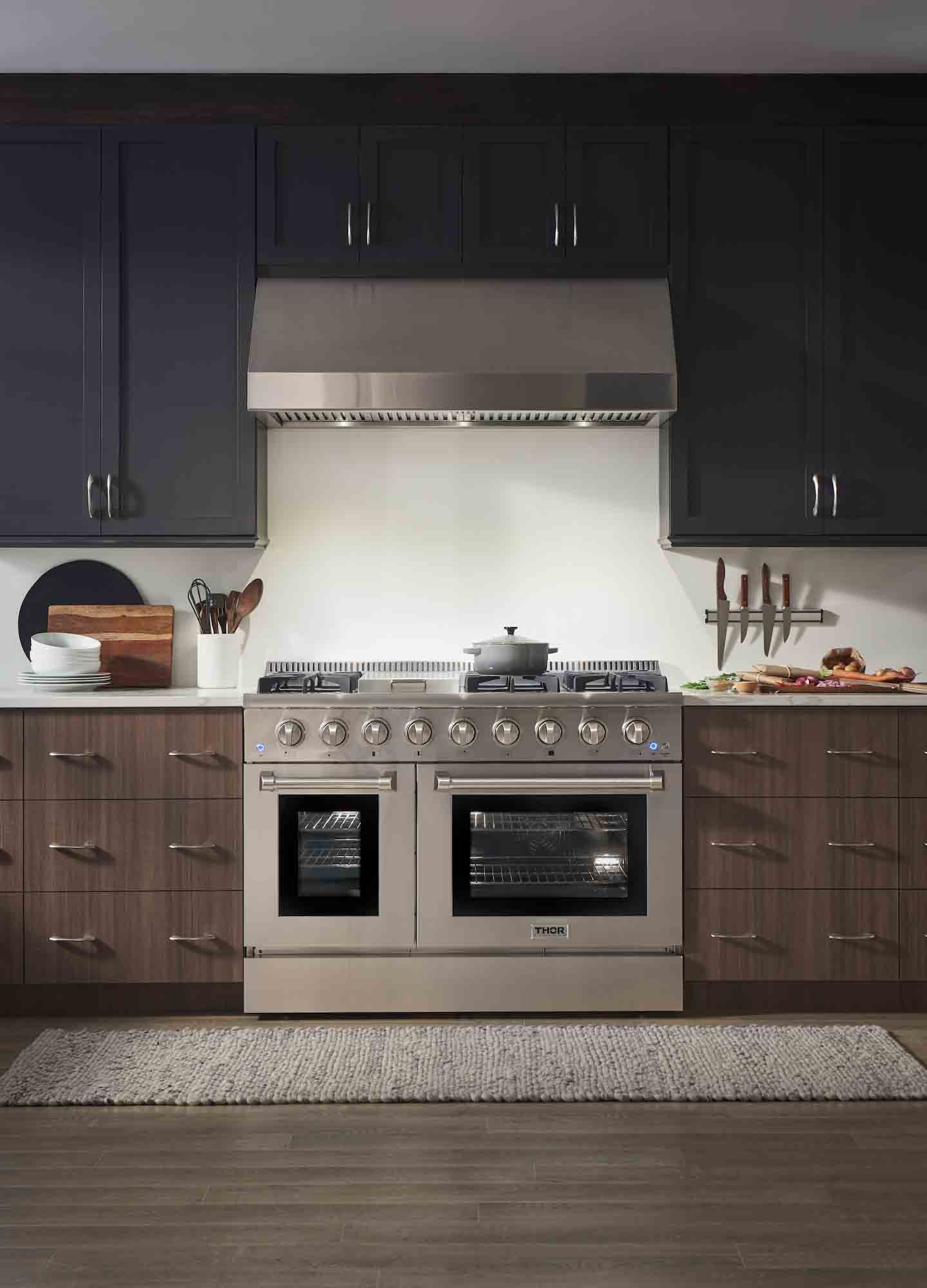 Dual fuel range and under-cabinet hood package in stainless steel, front view.