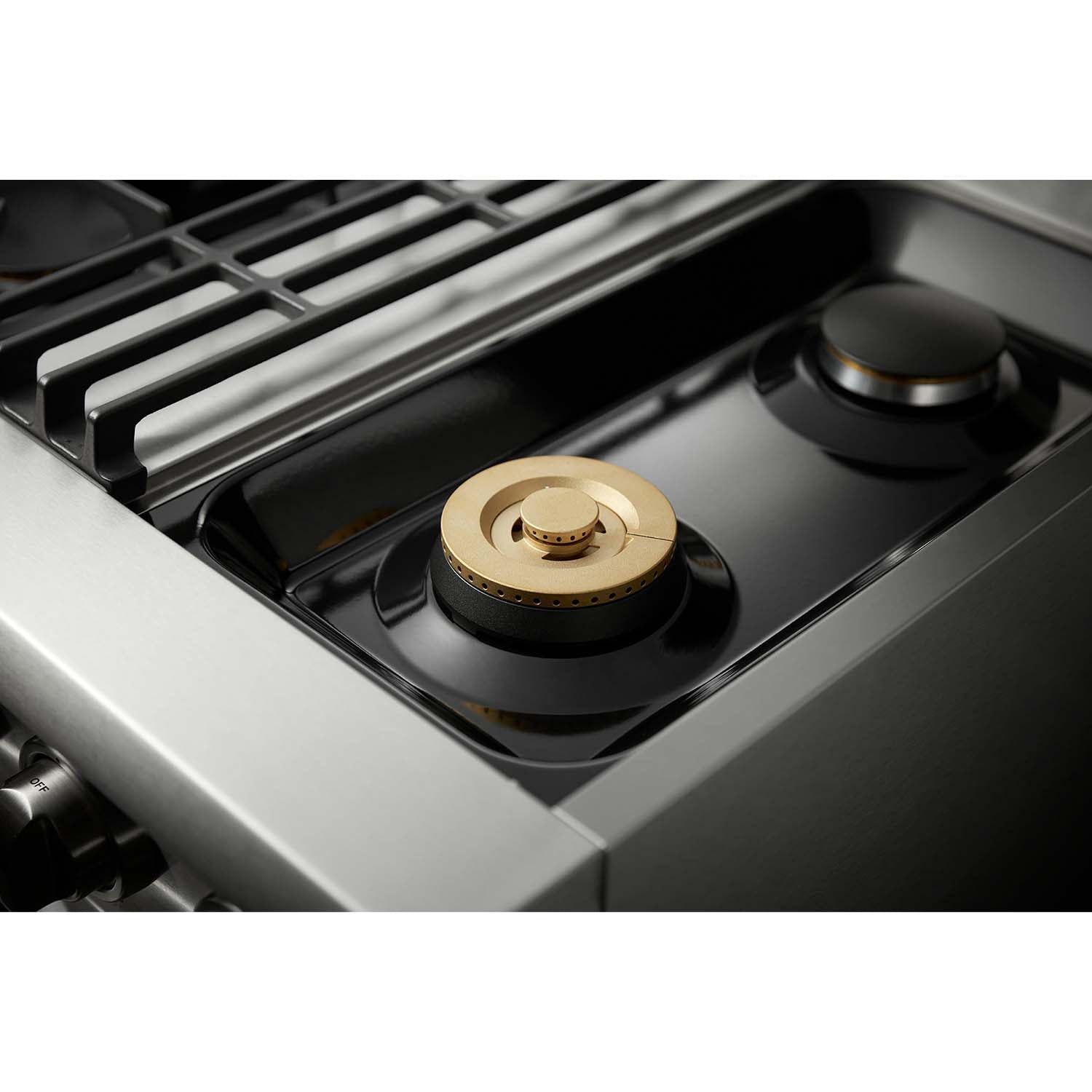 Stainless steel dual fuel range cooktop with black burner and round brass cap
