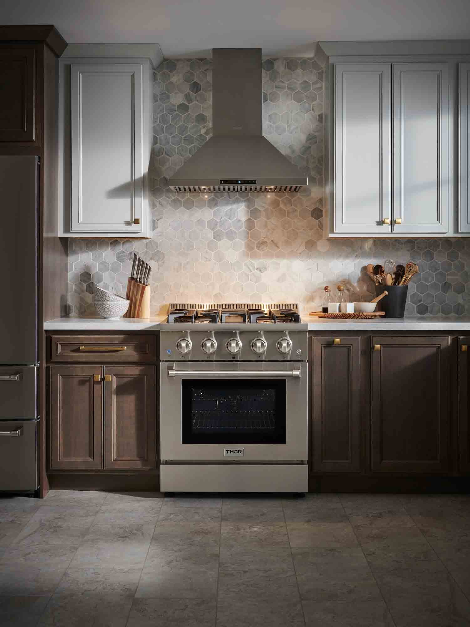 Stainless steel dual fuel range with oven door closed and four gas burners on top