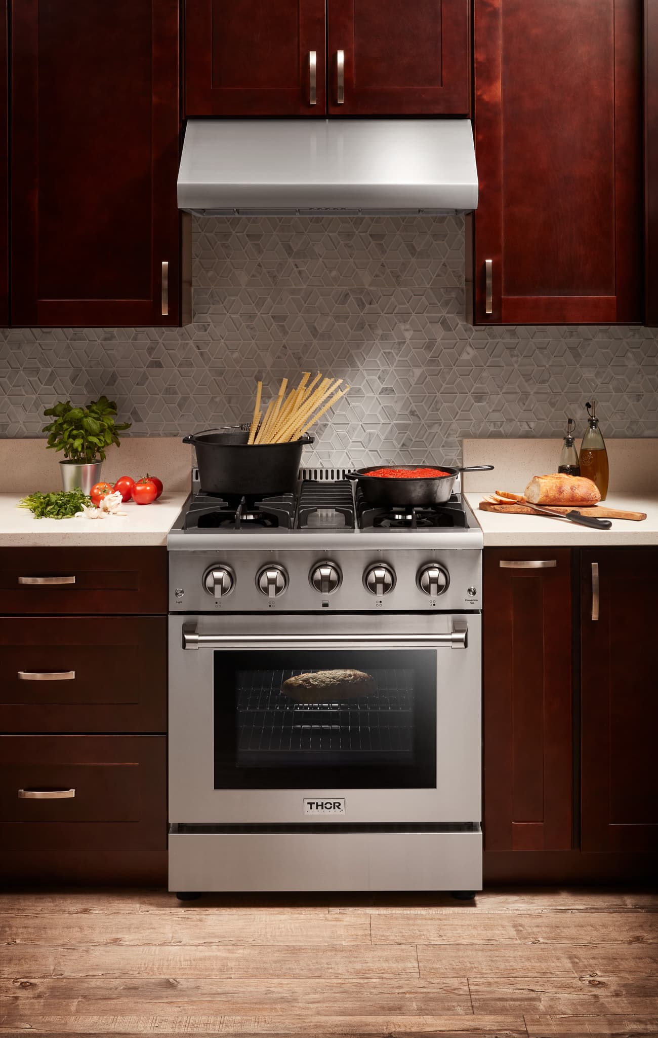Stainless steel gas range with cooktop burners and closed oven door