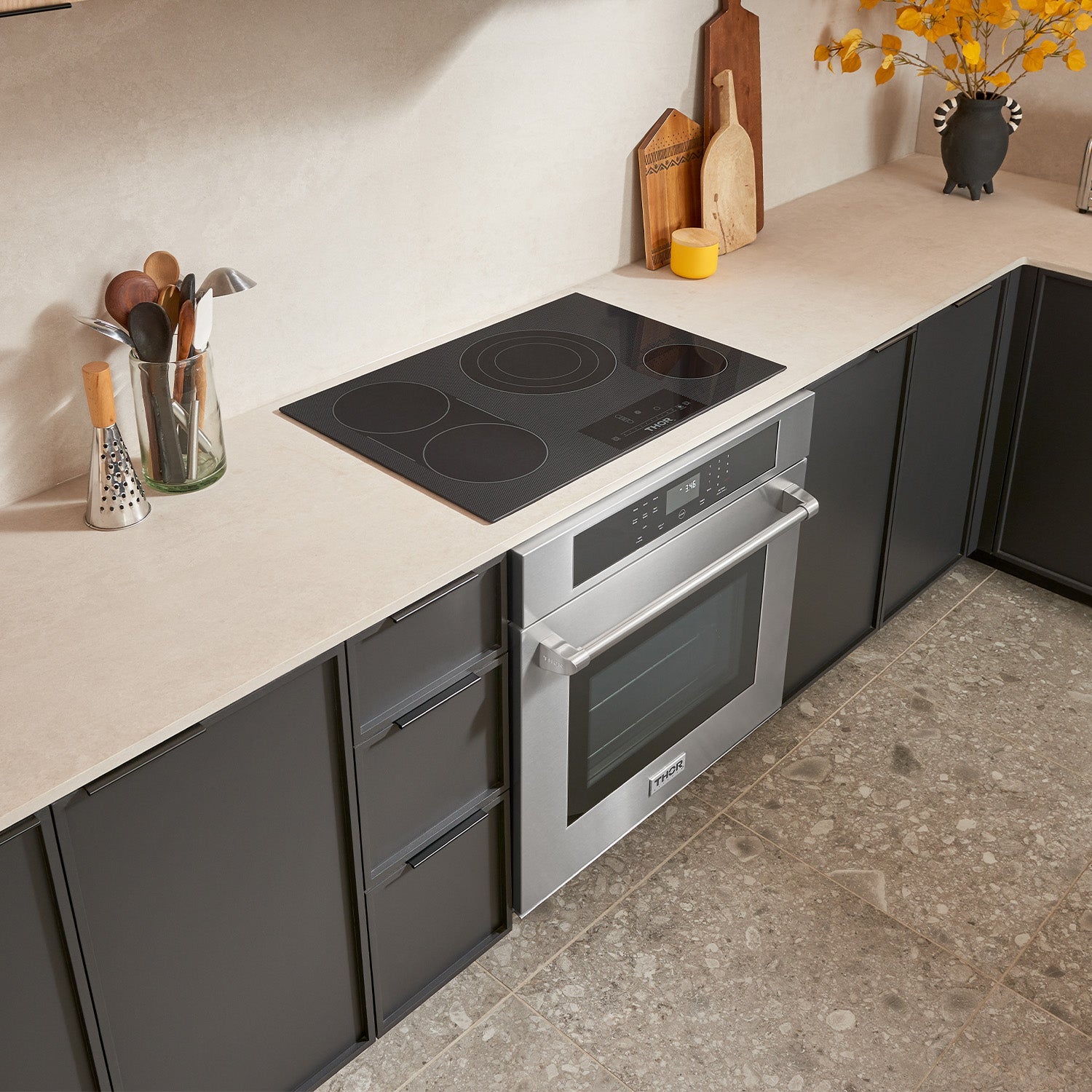 Black electric cooktop with four round burners and digital control panel