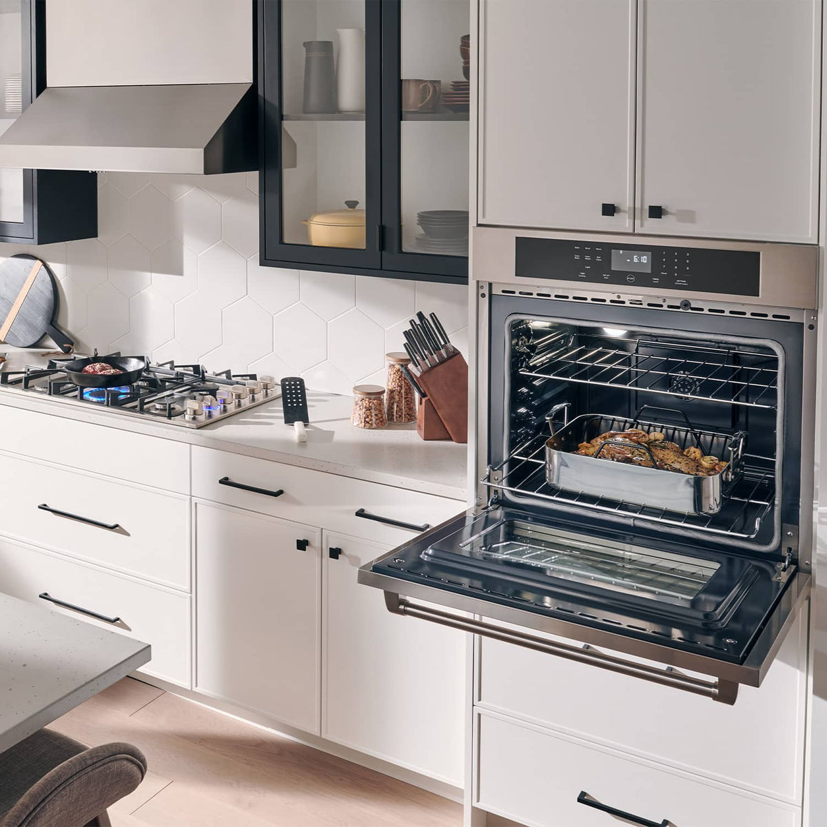 Built-in gas cooktop with stainless trim and oven, black control panel