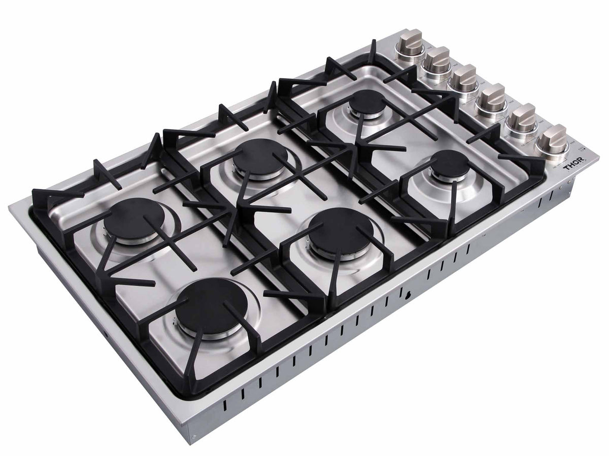 Six-burner stainless gas cooktop with black grates and burner caps, control knobs on right