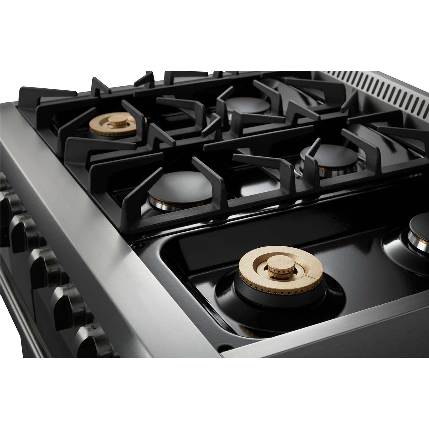 Close-up of stainless steel gas range burner grates and brass-toned burner caps, Thor.