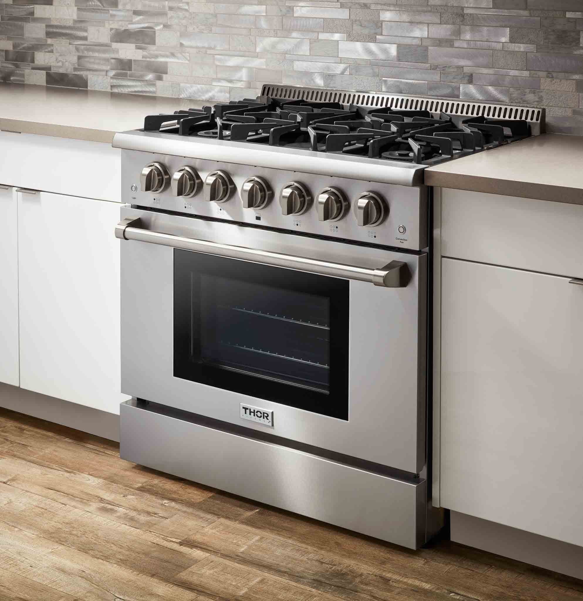 Stainless steel 36-inch gas range with burner grates, control knobs, and oven door, Thor.
