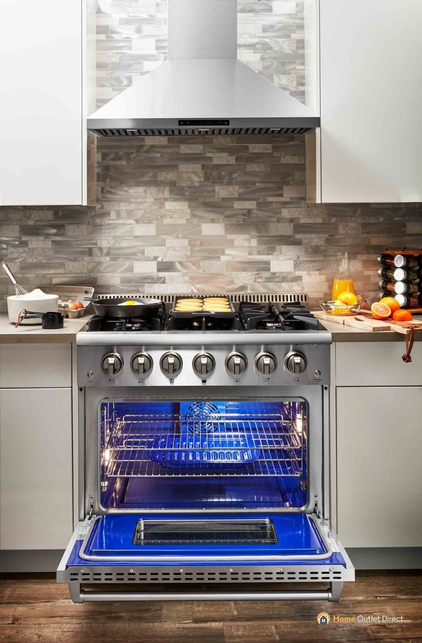 Stainless steel gas range with vent hood and open oven with rack