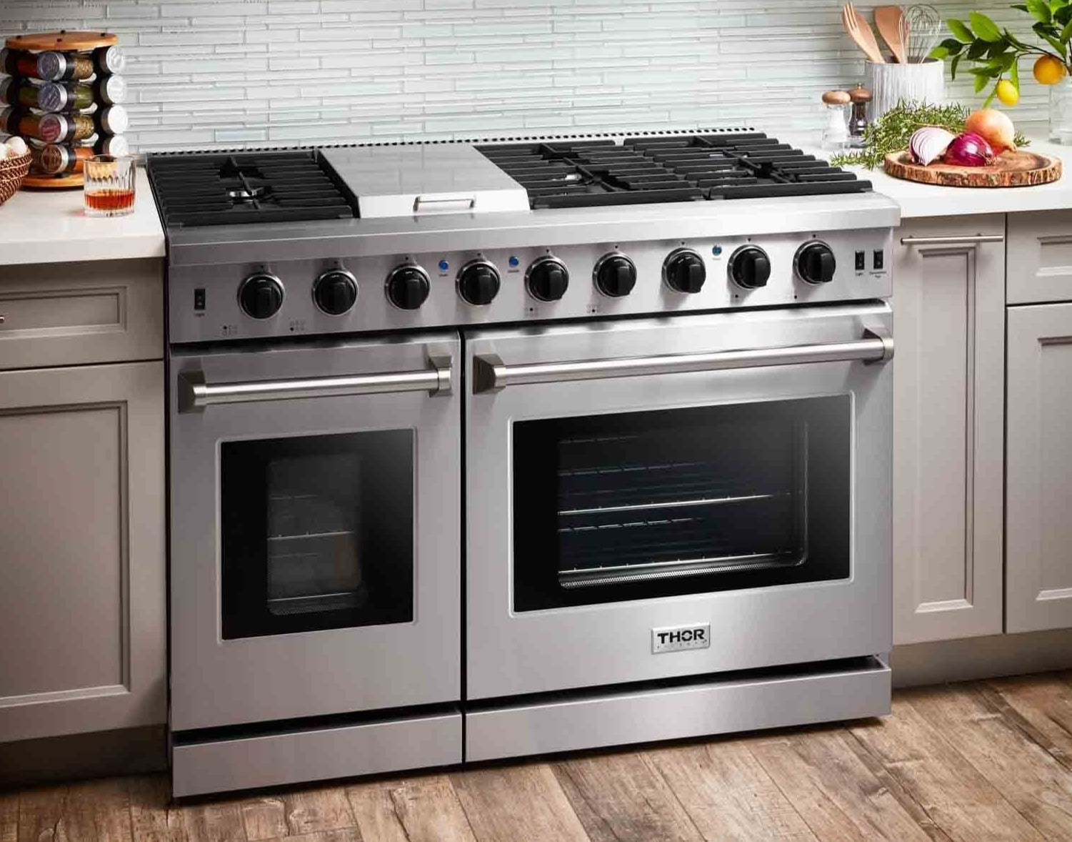 Stainless steel double oven gas range with two oven windows and control knobs