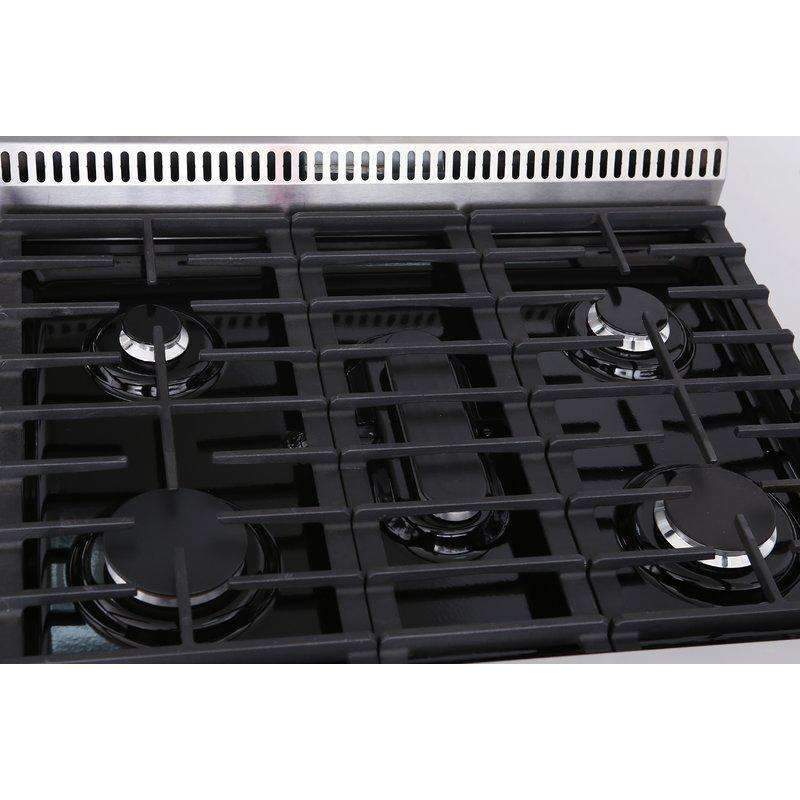 Close-up of black cast-iron gas burner grates on a stainless cooktop