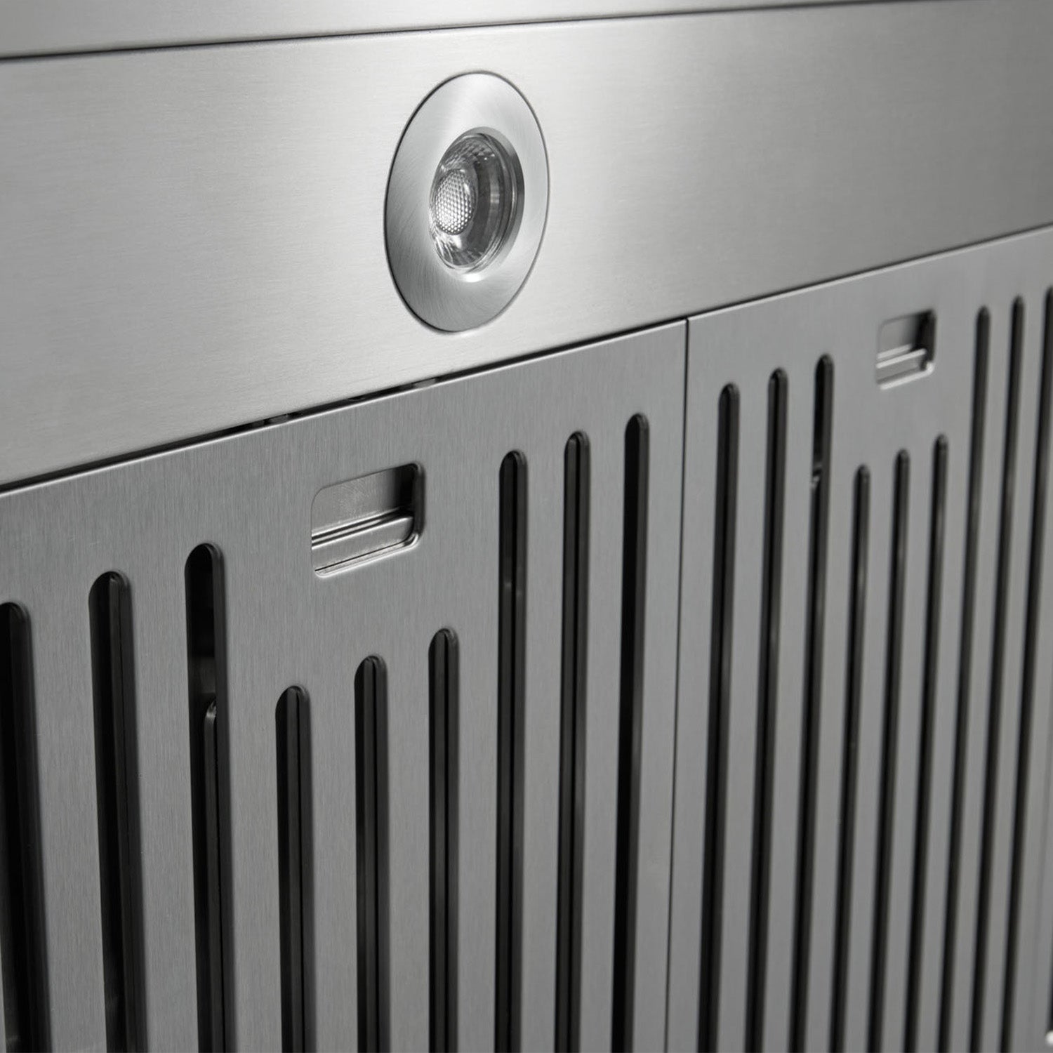 Stainless steel range hood vent grilles and round light lens detail